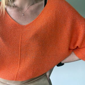 Oranje glittertruitje met halflange mouwen